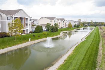 Small pond with a fountain in the middle of an apartment complex